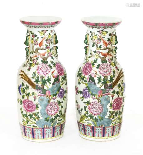 A pair of Chinese famille rose vases, 20th century, each painted with phoenixes standing on a rock ...