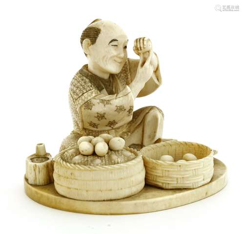 A Japanese ivory okimono, c.1920, of a merchant seated, examining each egg he is selling from the ...