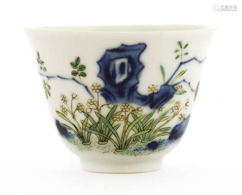 A Chinese wucai wine cup, Kangxi (1662-1722), painted with flowering narcissus by rocks, six ...