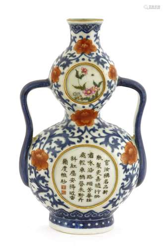 A Chinese blue and white wall vase, in the shape of a double gourd with two handles, painted with ...