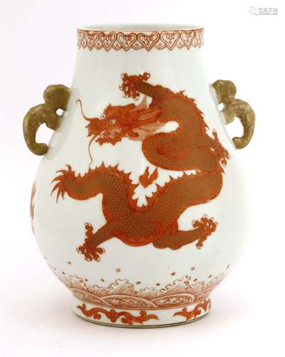 A Chinese iron-red vase, painted with dragons chasing a flaming pearl above spuming waves, two ...