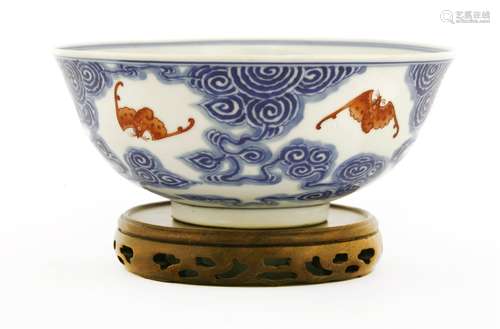 A Chinese blue and white bowl, possibly Guangxu (1875-1908), painted with bats in iron red amongst ...