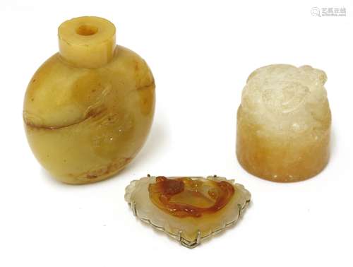 A Chinese snuff bottle, carved with Daoist emblems, 5.5cm long, an agate brooch with a Buddhist ...