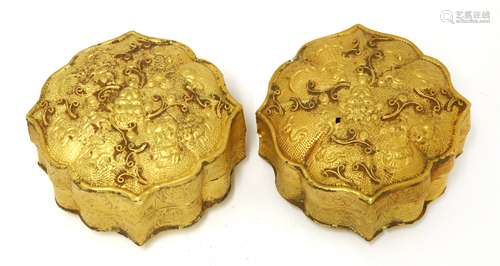 A pair of Chinese gold boxes and covers, of lobed square form, decorated with a seated Buddha in ...