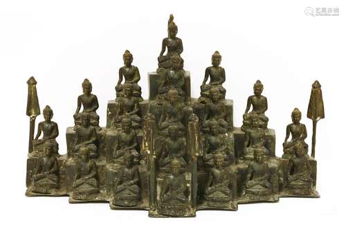 A Thai bronze group, 20th century, of twenty-three buddhas, all seated on lotus seats on a stepped ...