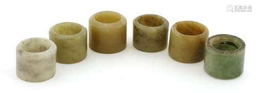 Six Chinese jade archer's rings, Qing dynasty (1644-1911), of typical plain form, 2 to 2.4cm high ...