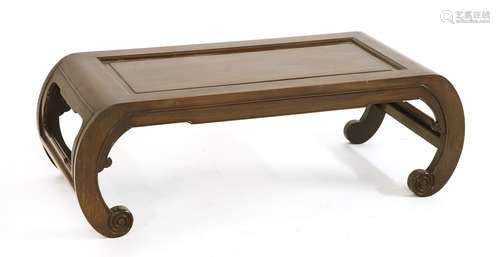 A Chinese kang table, early 20th century, the rectangular top with a slender apron on four scroll ...