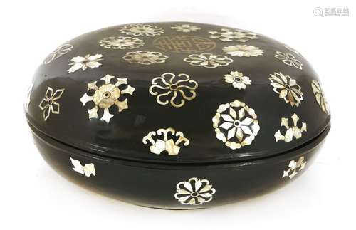 A Chinese lacquered box and cover, of circular form, decorated with flowers inlaid with ...