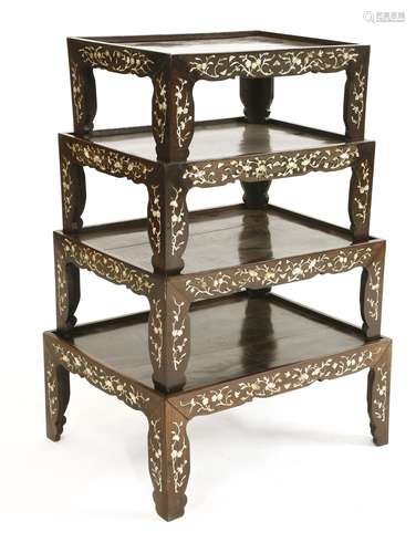 A set of four Chinese graduated tables, early 20th century, each with a shaped apron and legs ...