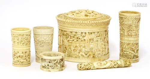 A collection of Chinese ivories, late 19th century, a box and cover, profusely carved with figures ...