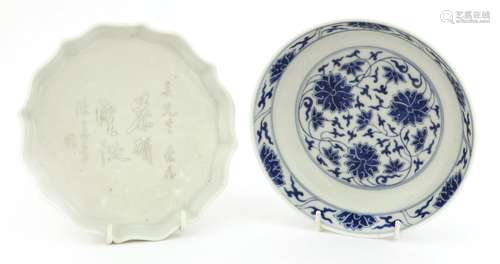 A Chinese circular dish, c.1900, with lobed rim, covered in a white glaze, with engraved Chinese ...