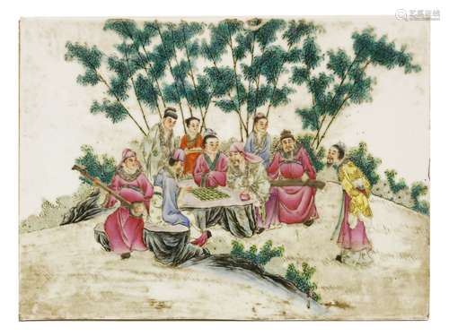 A Chinese ceramic plaque, painted with literati playing go on a rock in a bamboo forest, surrounded ...