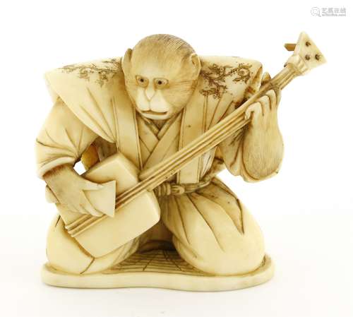 A Japanese ivory okimono, Meiji period (1868-1912), depicting a kneeled monkey playing a shamisen, ...