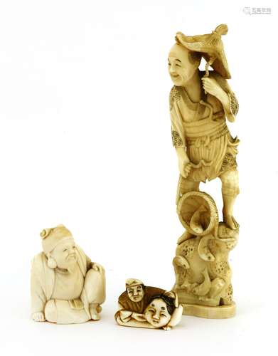 A collection of three Japanese ivory carvings, c.1900, one of a fisherman, 19cm high, a scholar, ...