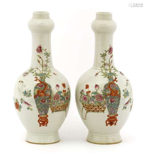 A pair of Chinese famille rose vases, each of globular form with a garlic mouth, painted with ...