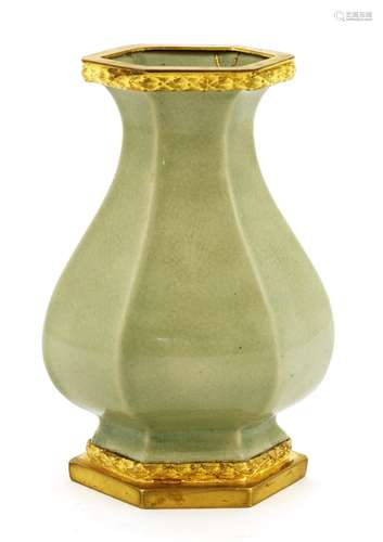 A celadon vase, early 20th century, of hexagonal baluster form with flared mouth and base, mounted ...