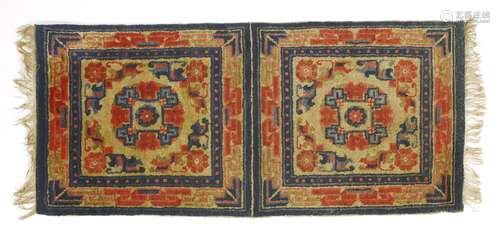 A Chinese Ningxia double mat, decorated with florets in red and blue against a yellow ground, 57 x ...