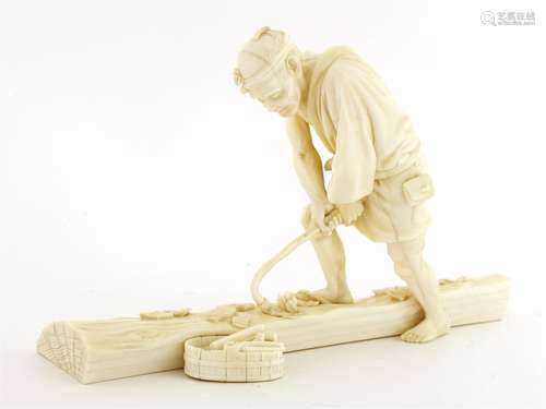 A Japanese ivory okimono, Meiji period (1868-1912), of a carpenter standing on a section of log ...