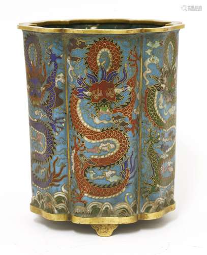 A Chinese cloisonné brush pot, of lobed form, enamelled with dragons amongst clouds above waves, on ...