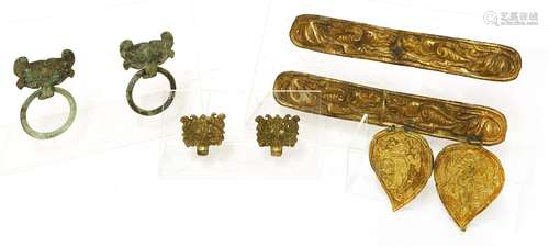 A pair of Chinese silver gilt plaques, each of shaped rectangular form, decorated with two ...