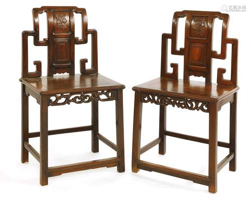 A pair of Chinese side chairs, 19th century, the backs in the shape of key frets, the central ...