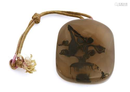 A Chinese agate pendant,  Qing dynasty (1644-1911), carved with a magpie standing on a prunus tree, ...