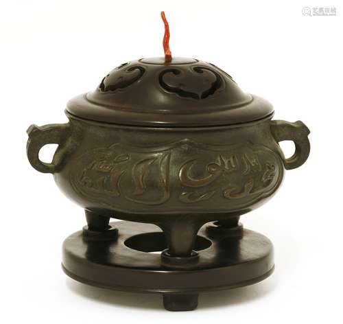 A Chinese bronze incense burner, Qing dynasty (1644-1911), of squat circular form on three stub ...