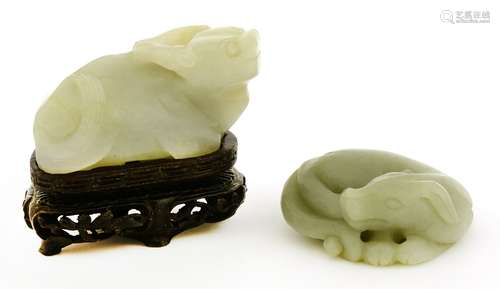 A Chinese pale celadon jade carving, 19th century, of a reclining two-horned buffalo, his head ...