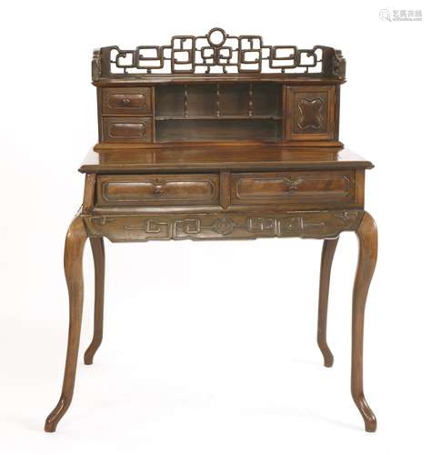 A Chinese writing desk, 19th century, the pierced and carved key fret gallery above two drawers, ...