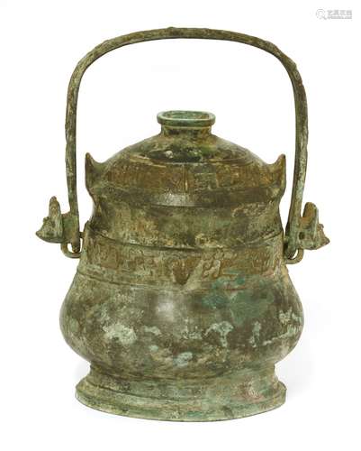 A Chinese archaic wine vessel and cover, yue, Zhou dynasty or later, of oval form, the slightly ...