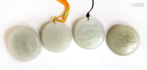 Four Chinese jade pendants, 20th century, of oval form, carved with figures, chickens or carps, ...