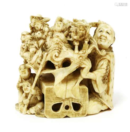 A Japanese ivory okimono, Meiji period (1868-1912), of a seated storytelling man revealing Shichi ...