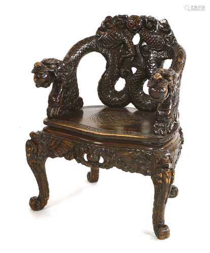 A Chinese armchair, early 20th century, the back pierced and carved with two entwined dragons, on ...