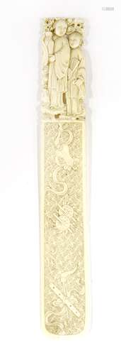 A Chinese ivory page-turner,  Qing dynasty (1644-1911), the handle carved with two ladies standing ...