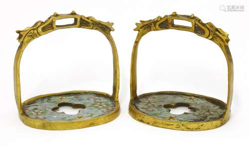 A pair of Chinese cloisonné stirrups, early 20th century, each moulded in brass with two dragons ...