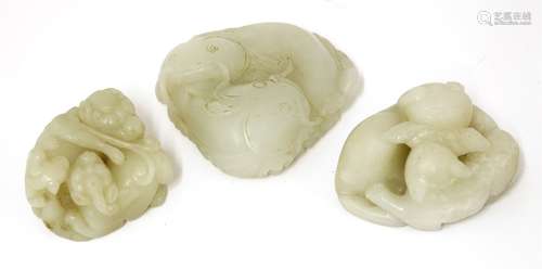 A collection of three Chinese jade groups, 20th century, comprising: one with two carps over waves, ...