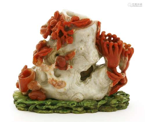 A Chinese agate vase, in the shape of a gnarled tree trunk surrounded by peaches, pomegranates, ...