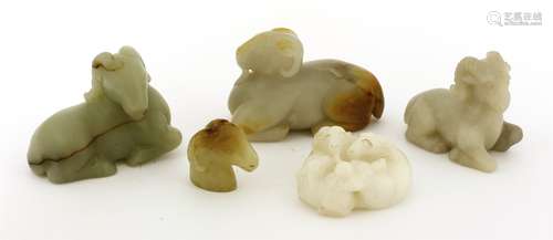 A collection of Chinese jade rams, 20th century, comprising three recumbent examples, a model of ...