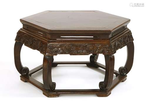 A Chinese hongmu hexagonal faceted table, c.1860, carved in relief on the apron with flowers, ...