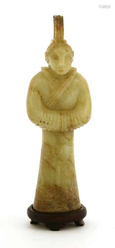 A Chinese jade figure, in the archaic style, standing wearing a tall hat and a long robe engraved ...