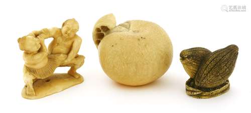 A Japanese ivory okimono, Meiji period (1868-1912), of an orange, 5cm long, a netsuke of two ...