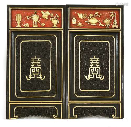 A pair of Chinese gilded wooden panels, early 20th century, each carved with a shou character ...