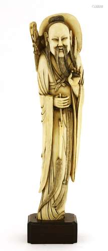 A Japanese ivory figure, late 19th century, of Lü Dongbin standing in a long robe, with a fly whisk ...