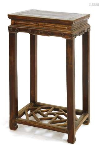 A Chinese hardwood stand, c.1900, the rectangular top above a carved apron, on square section ...