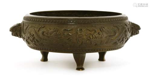 A Chinese bronze tripod censer, 18th century, of circular drum shape, the body cast with two pairs ...