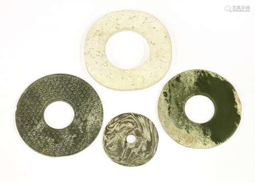 A collection of four Chinese jade bi discs, comprising: a white example,  possibly of Liangzhu ...