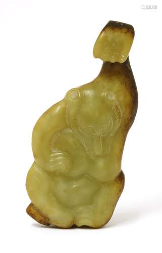 A Chinese jade belt hook, in the shape of a bear with a raised left arm forming the hook, the stone ...