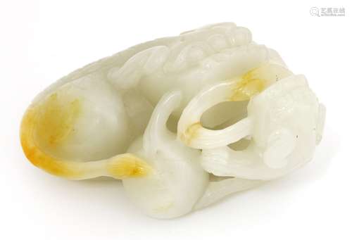 A Chinese jade carving, of a Buddhist lion, playing with a ball with two pups, the stone of white ...