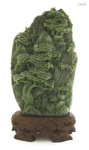 A Chinese jade carving, of two scholars standing on a bridge under a pine tree, amongst pavilions ...