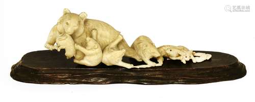 A Japanese ivory okimono, Meiji period (1868-1912), of a bear and three pups catching rabbits, 19cm ...